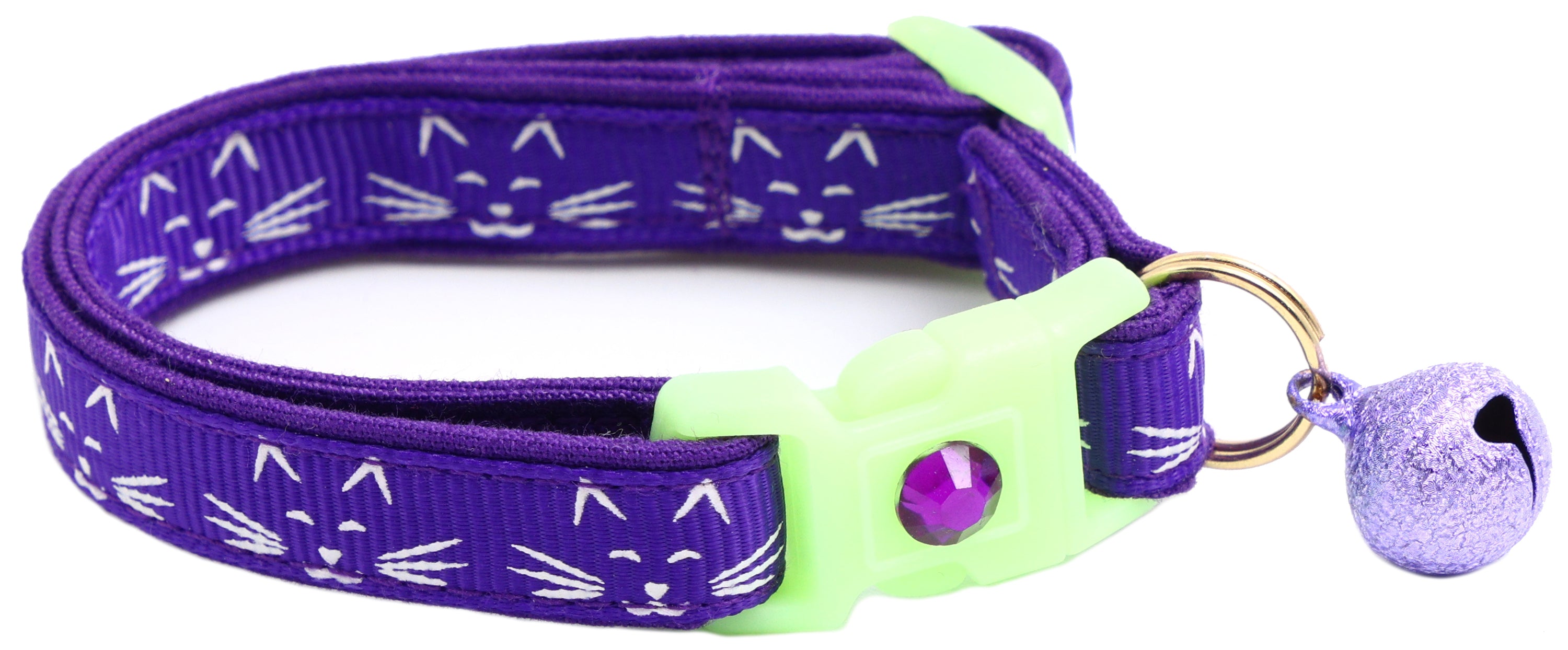 A glowing cat faces breakaway collar made of reinforced cotton, featuring a bell and charm, perfect for nighttime visibility.